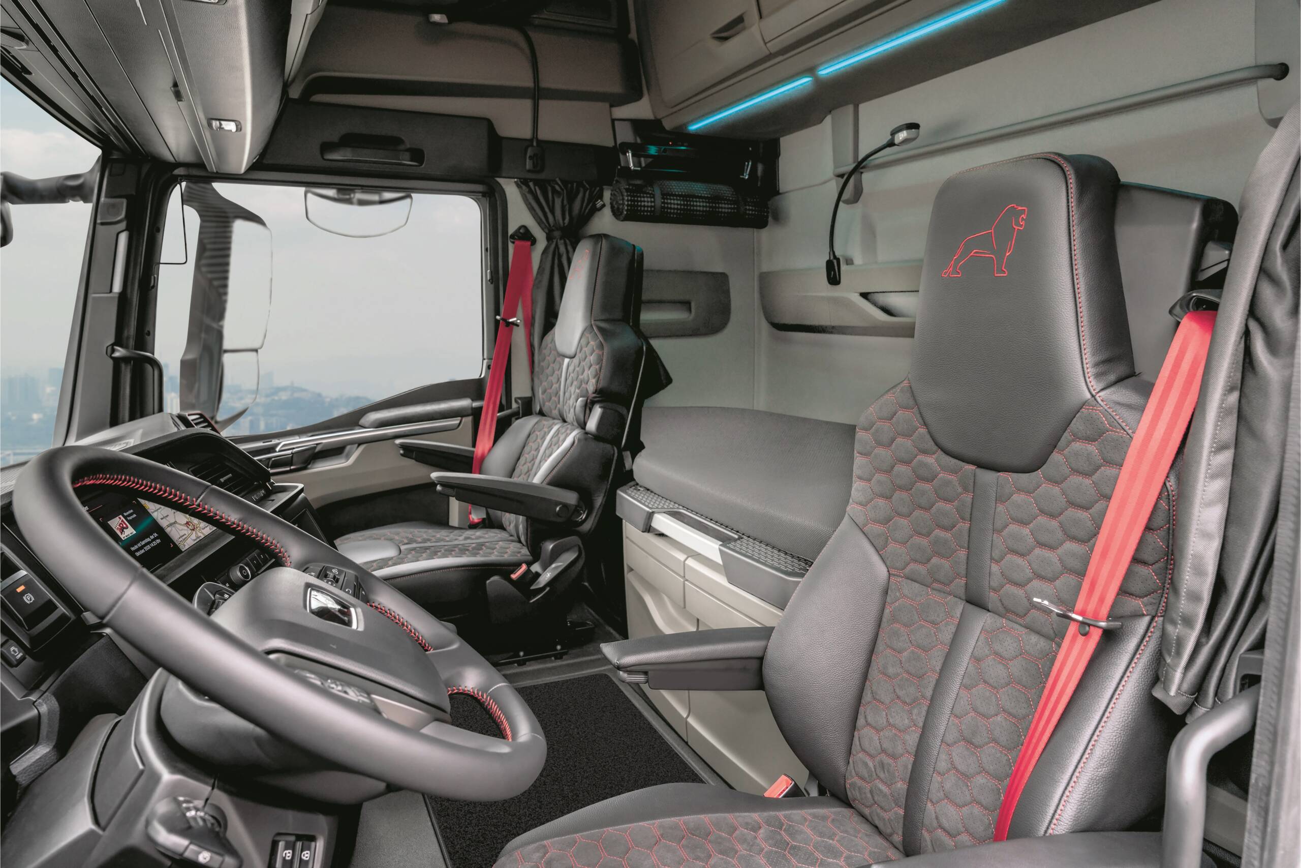 "We are very pleased with the first place for our MAN TGX Individual Lion S in the driver cab comparison test conducted by the trade magazine FERNFAHRER," says Friedrich Baumann, Member of the Executive Board for Sales & Customer Solutions at MAN Truck & Bus SE. "Our focus is consistently on ensuring that drivers feel comfortable in their job, which is so important for all of us. That's why we asked for their practical expertise when developing our new truck generation and have consistently incorporated it."  The trade magazine FERNFAHRER tested four long-distance vehicles in terms of cabin comfort and driver friendliness. They judged the largest long-distance cab from MAN as well as the three market competitors DAF, Mercedes and Scania in the top equipment. MAN sent its top model, the MAN TGX-18.640 (640 hp) Individual Lion S, into the race. The test results were published in FERNFAHRER 10/2022: MAN took first place with 460.5 out of 500 maximum points, which were awarded in various criteria.  "True size is not only measured in the number of centimetres from the front to the rear or the interior volume of the cab," the testers write in their verdict. "Quality of operation and coherence of the interior design, driving comfort as well as the long bar of today's safety and assistance systems: All this adds up to a comprehensive truck interior in which everything should mesh as well as possible."  And here the MAN TGX Individual Lion S with its wide and high GX cab was the most convincing. The jury praised the attractiveness of the new MAN truck generation. The top equipment of the test model was particularly appealing: "A feast for the eyes inside and out". Among other things, the easy entry and the interior with various storage compartments were highlighted. The centre square and the space above it were considered spacious. The rear wall module impressed with its capacity of around 470 litres and its permanently installed set of microwave and coffee maker. The testers also praised the two available 230 V sockets. In their assessment, the testers also highlighted the control module in the sleeping area, which, in addition to the usual comfort applications, also allows the control of on-board computer functions from the couch. The extra bar for the four switches in the lower area of the driver's door and the steering wheel, which can be raised completely horizontally when the MAN TGX is parked, also attracted positive attention. The intuitive operation of digital and analogue functions was also praised by the testers.  In the overall ranking, the MAN TGX Individual Lion S is thus ahead in the test of the very large cabs. The conclusion of the specialist editors: "With the TGX, MAN shows that a careful, clever fusion of tradition and modernity can develop a very special charm.